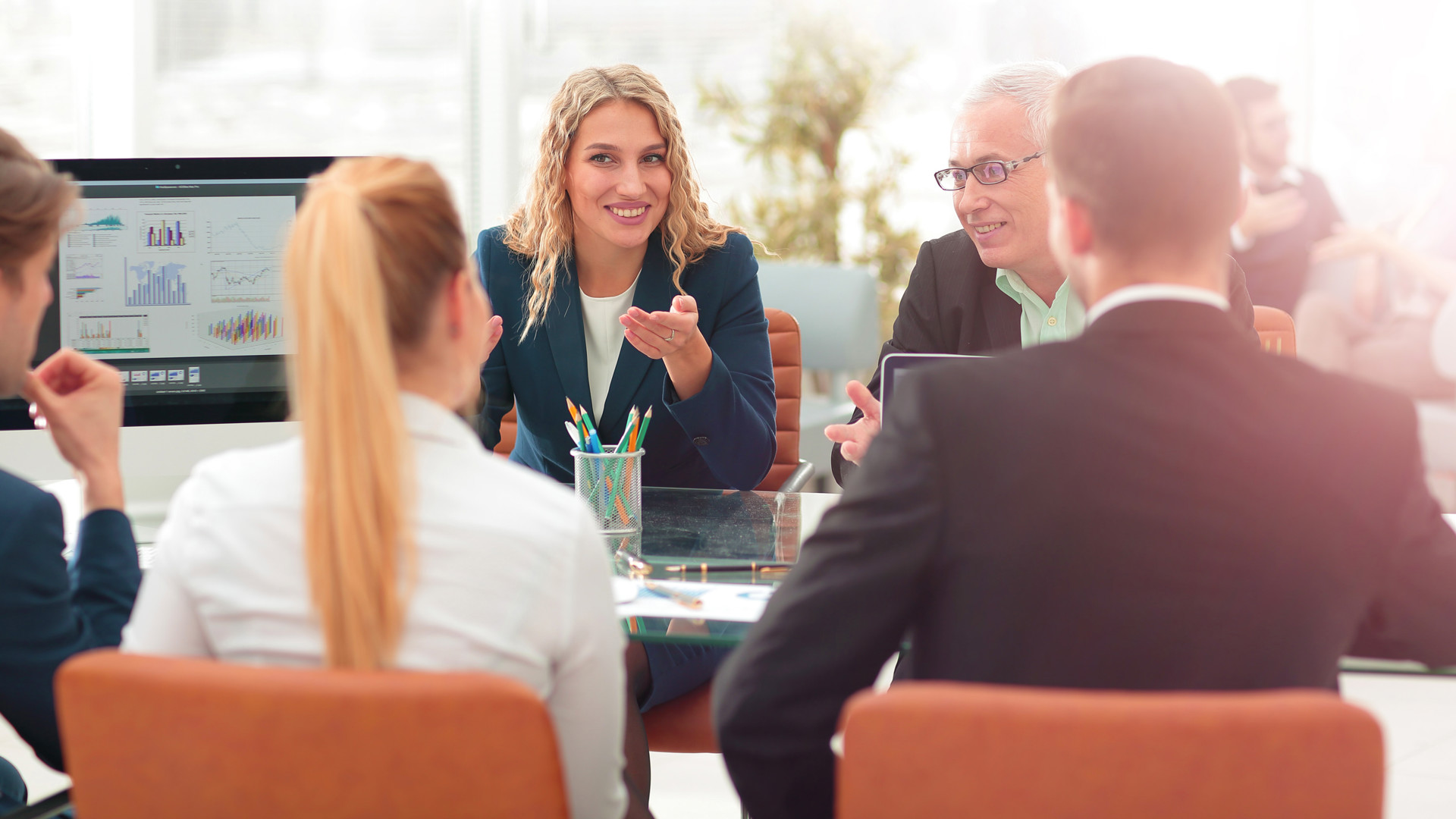 People meeting and talking around a table in a professional setting